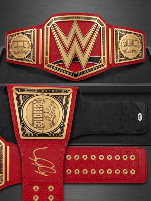 حزام بطولة WWE موقع من بيل جولدبيرج، ومكتوب عليه "من التالي؟" (Who's Next?)، وهو معتمد من PSA.